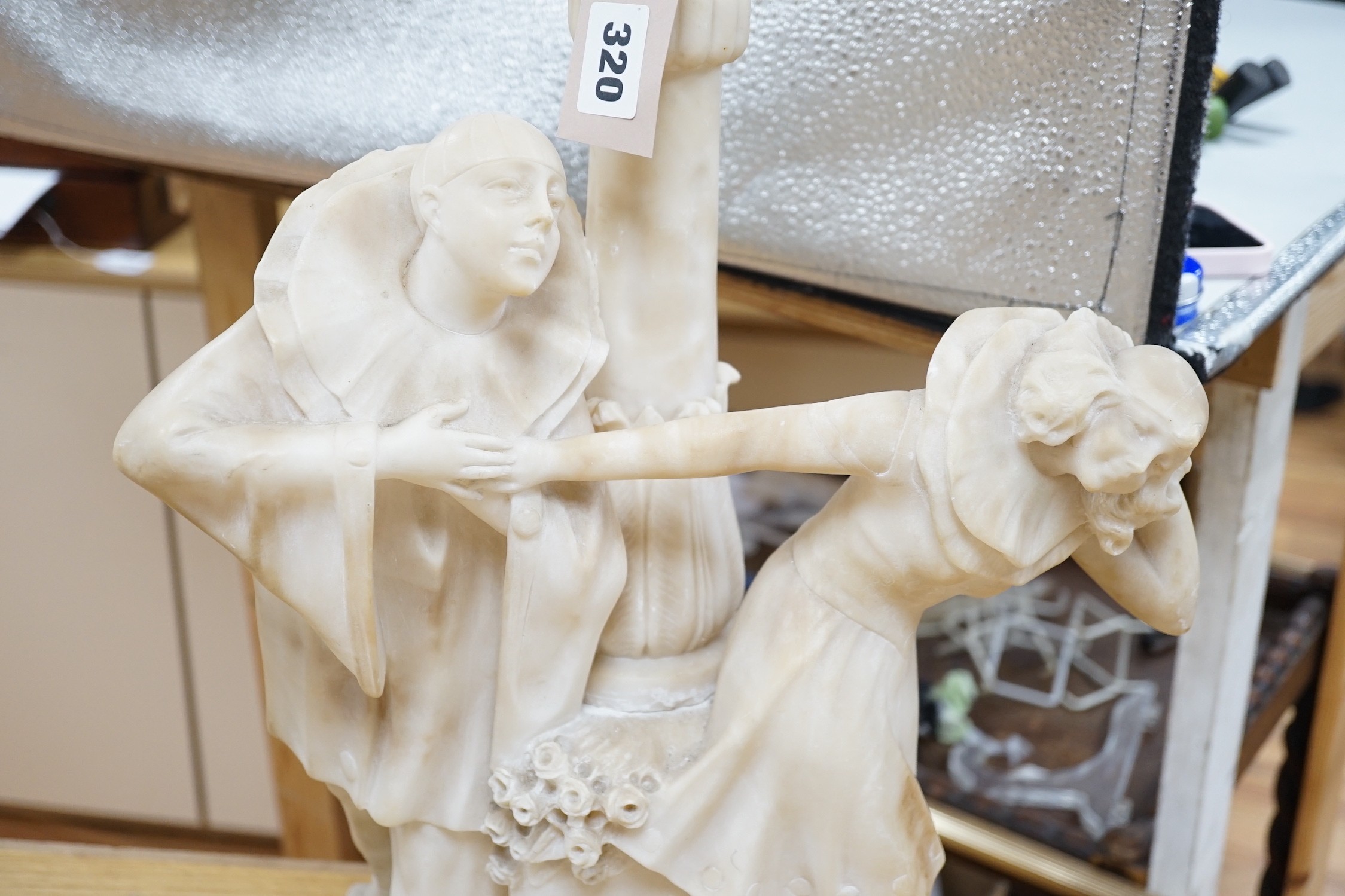 A 1920's carved alabaster clown group figure lamp. 85cm tall